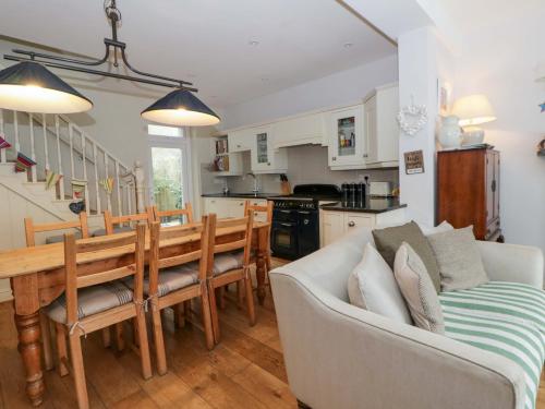 a kitchen and living room with a table and a couch at Rose Cottage in Cardigan