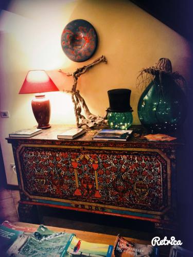 a table with a lamp and other items on it at Il Peschio in Pescocostanzo