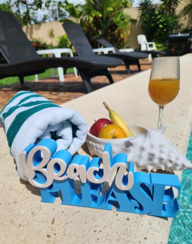 a bowl of fruit and a glass of wine at Coral Island Suites Cozumel in Cozumel