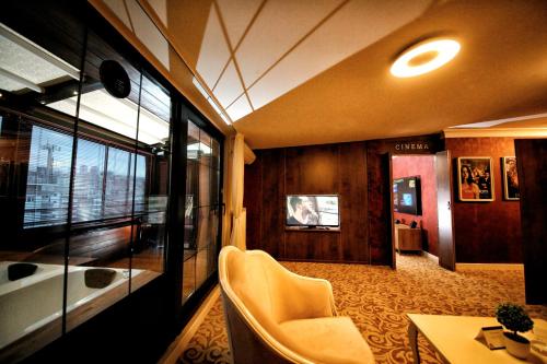 a room with a couch and a table and chairs at My Suit Residence & Hotel in Samsun