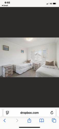two pictures of a bedroom with two beds at 3 Mile in Lennox Head