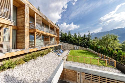 an external view of a building with a garden at Hotel Lajadira & Spa in Cortina dʼAmpezzo