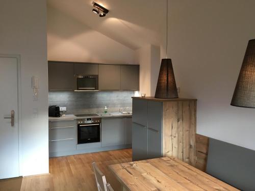 a kitchen with a table and a stove top oven at Ferienwohnung Neubau in Alpbach