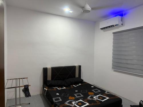 a bedroom with a bed in the corner of a room at DF Homestay in Kangar