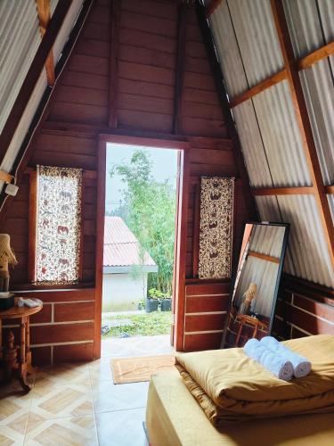 a room with a bed and a window in a house at VANY Glamping in Pasuruan