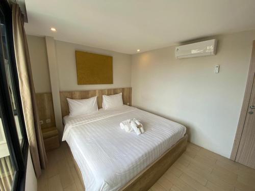 a bedroom with a bed with a white towel on it at Allende Canggu in Canggu