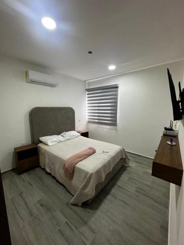 a bedroom with a bed and a window at Depto Vista Cañón del Sumidero in Cerro Hueco