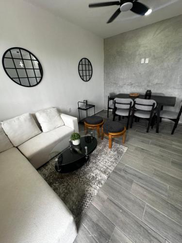 a living room with a couch and a table at Depto Vista Cañón del Sumidero in Cerro Hueco