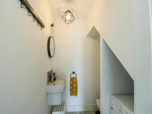 a bathroom with a sink and a mirror at Dune Retreat in Rhosneigr