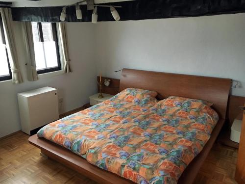a bedroom with a bed with a colorful comforter at Ferienhaus FachWerk in Holler