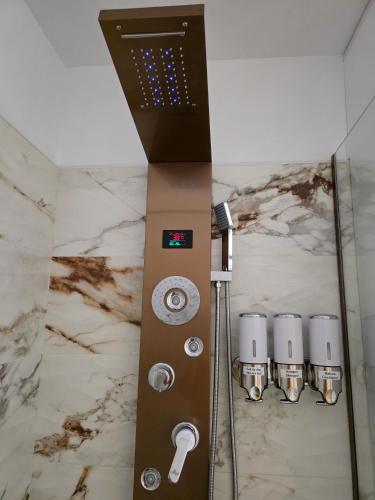a control panel in a shower in a bathroom at Badash Tiny Village - Tiny Houses with Heated Pool & BBQ in Polovragi