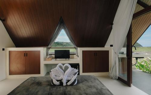 a room with a large window and a bed at Limbo Lux Bungalows in Kuta Lombok