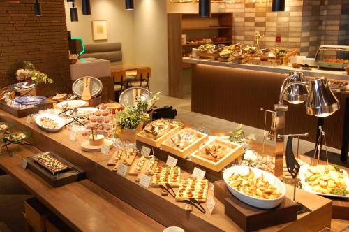 a buffet line with many different types of food at Hotel Global View Hakodate in Hakodate