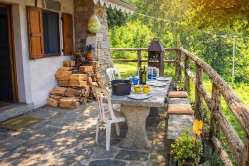 a table on the porch of a house at Ca Brunella 2 Lake Maggiore View Terrace for Four - Happy Rentals in Riazzino