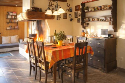 a dining room with a table with chairs and a kitchen at Ca Brunella 2 Lake Maggiore View Terrace for Four - Happy Rentals in Riazzino