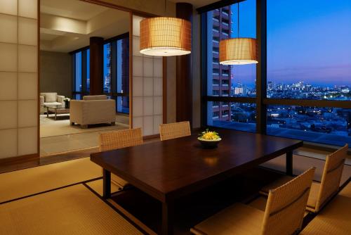a dining room with a table and a view of the city at Grand Hyatt Tokyo in Tokyo