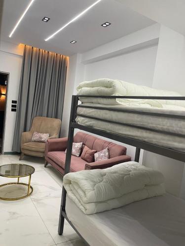 a living room with two bunk beds and a chair at 6th october luxury studio 2 in 6th Of October