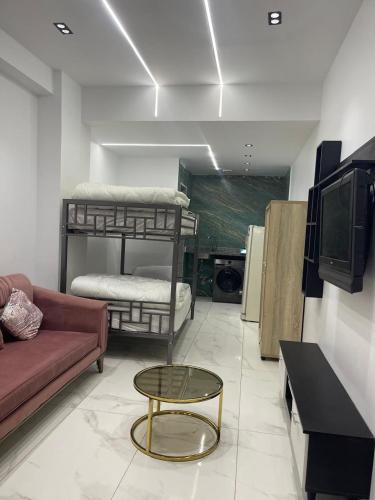 a living room with two bunk beds and a table at 6th october luxury studio 2 in 6th Of October