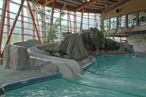 a swimming pool with a waterfall in a building at River Rock Casino Hotel in Richmond