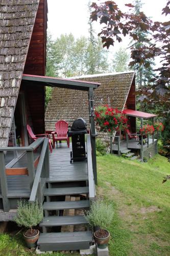a wooden stairs leading to a cabin with a grill at Sunny Bluffs Chalets in Kaslo