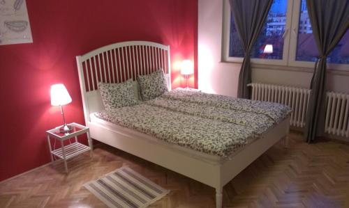 a bedroom with a white bed and two lamps at Budanest Apartments in Budapest