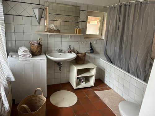 a small bathroom with a sink and a shower at Haus Adele in Drochtersen