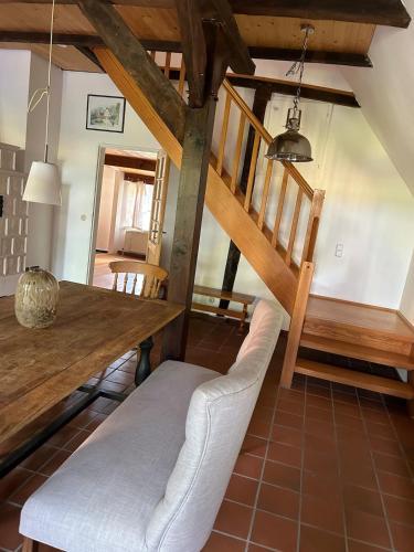 a dining room with a wooden table and chairs at Haus Adele in Drochtersen