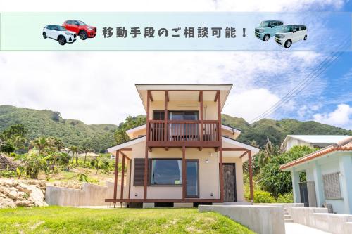 a house with a car parked in front of it at 新築!一棟貸切ヴィラ Sea Garden Ishigaki 提携レンタカー割引有り! in Ishigaki Island
