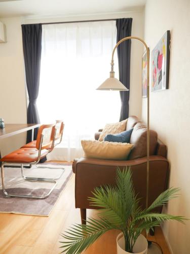 a living room with a couch and a table at MSTAY池袋one in Tokyo