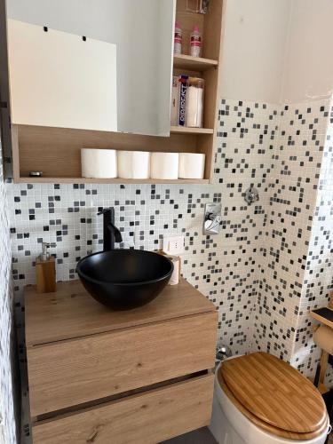 a bathroom with a black bowl sink on a counter at Colombo 49 Guest House in Gallarate