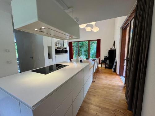 a kitchen with white counters and a long counter top at Haus Titschendorf in Wurzbach