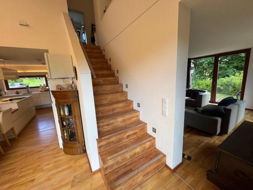 a living room with a staircase in a house at Haus Titschendorf in Wurzbach