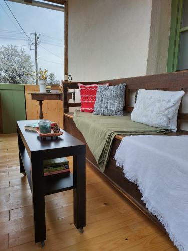 a bedroom with a bed and a table with a night stand at Mera Small House in Mera