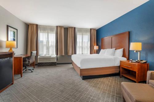 a large hotel room with a bed and a desk at Comfort Inn Madison near Clifty Falls in Madison