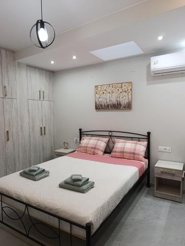 a bedroom with a bed with two towels on it at Luxury Rofos Residence in Elounda