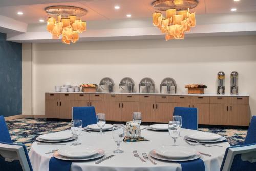 a conference room with a table and chairs and chandeliers at Doubletree By Hilton Wilmington, Nc in Wilmington