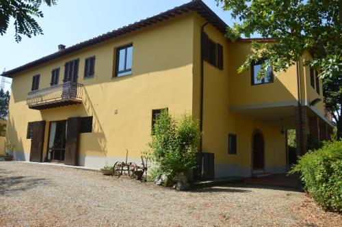 テッラヌオーヴァ・ブラッチョリーニにあるPodere San Lorenzoの砂利道付大黄色の家
