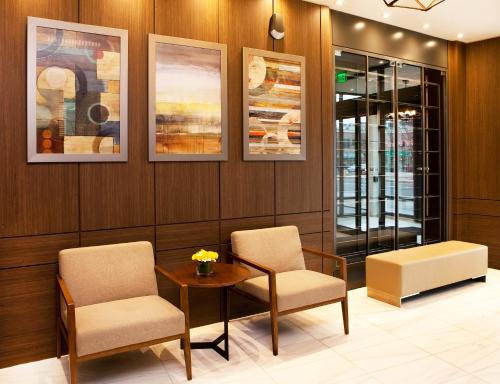 a waiting room with two chairs and a table at Porter Square Hotel in Cambridge
