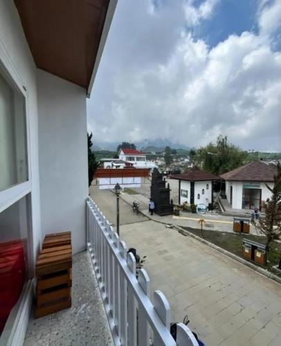 a balcony with a bench and a view of a street at Teras Candi Villa in Diyeng