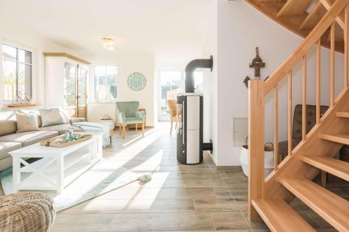 a living room with a couch and a refrigerator at Boddenbrise in Bresewitz