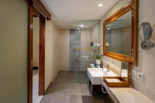a bathroom with a sink and a shower at Rama Residence Seminyak in Seminyak