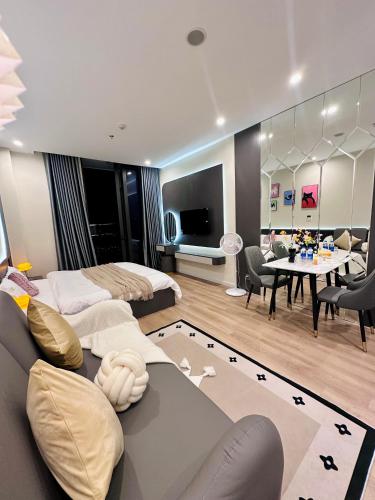 a living room with two beds and a dining room at ICON40 Homestay Hạ Long - Ocean View in Ha Long