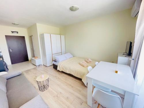 a bedroom with a bed and a desk and a table at Seaside Escape Studio in Byala