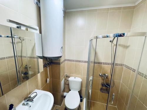 a bathroom with a shower and a toilet and a sink at Seaside Escape Studio in Byala