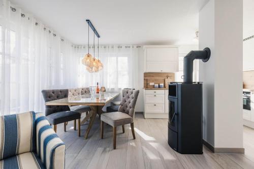 a kitchen and dining room with a table and a refrigerator at Kranichkieker in Zingst