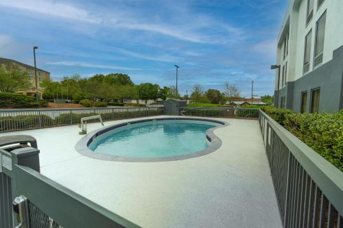 a swimming pool on a balcony of a building at Spark by Hilton Atlanta Kennesaw Town Center in Kennesaw