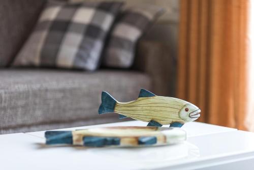a wooden fish toy sitting on top of a table at Neuland in Zingst