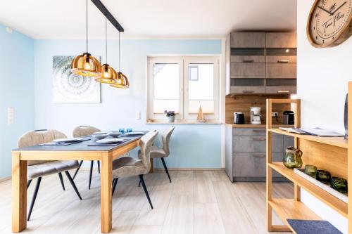 a kitchen and dining room with a table and chairs at Ostseelodge zwei in Fuhlendorf