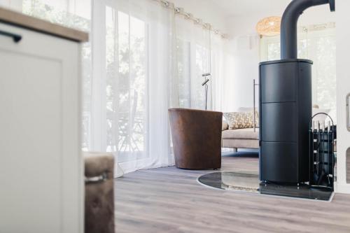 a fireplace in a living room with a couch at Sommersonne in Zingst