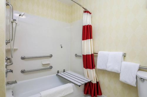 a bathroom with a red and white shower curtain at Residence Inn by Marriott Oklahoma City South in Oklahoma City